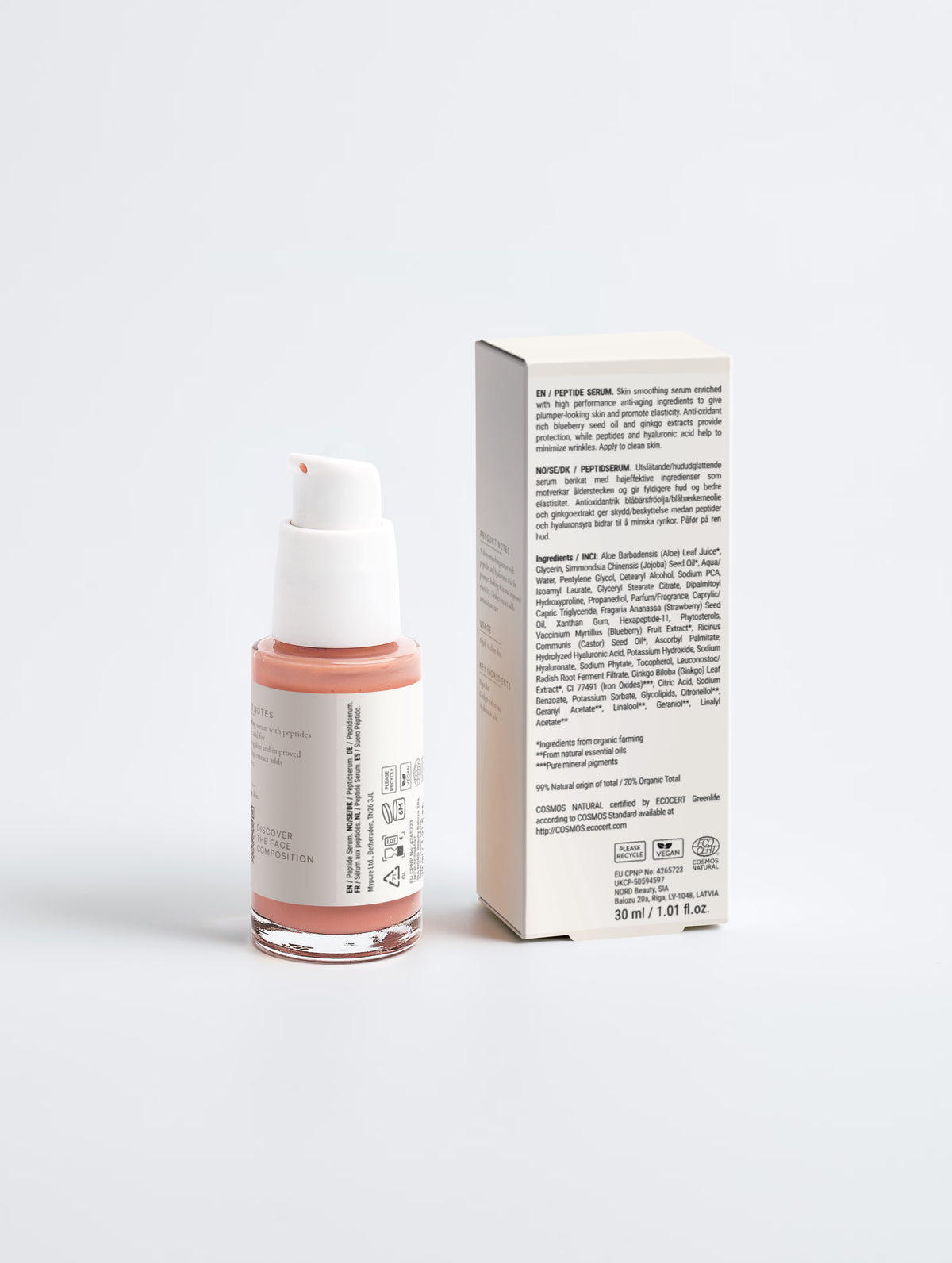 The bottle turned to its side panel with product notes and QR code, beside the carton's printed multilingual regulatory panel with the ingredients list.
