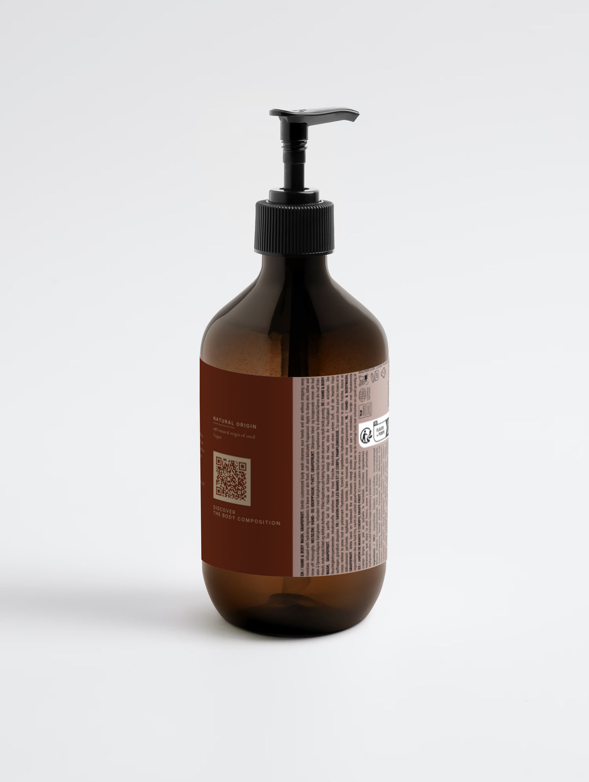 The 490 ml amber pump bottle turned to show the natural origin panel with the Body Composition QR code and the printed regulatory panel.