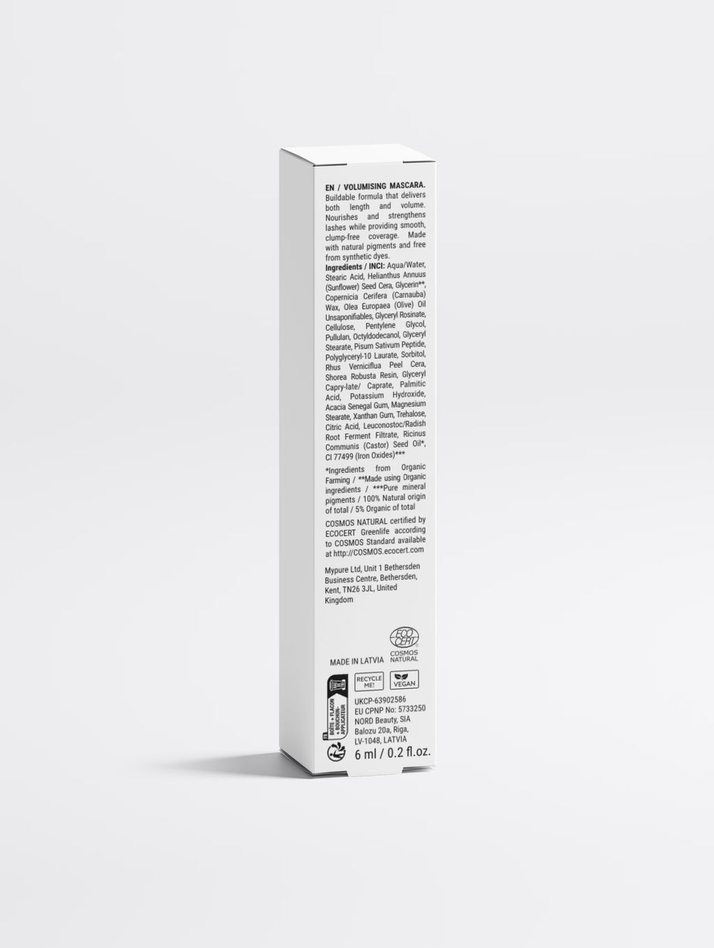 The mascara carton back panel, showing the printed multilingual regulatory text, the full ingredient list, COSMOS NATURAL and vegan marks, the responsible person addresses and MADE IN LATVIA.