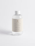 Glycolic Acid Exfoliating Toner — 250 ml SEV Apothecary bottle, The Face Composition, on a plain studio background.